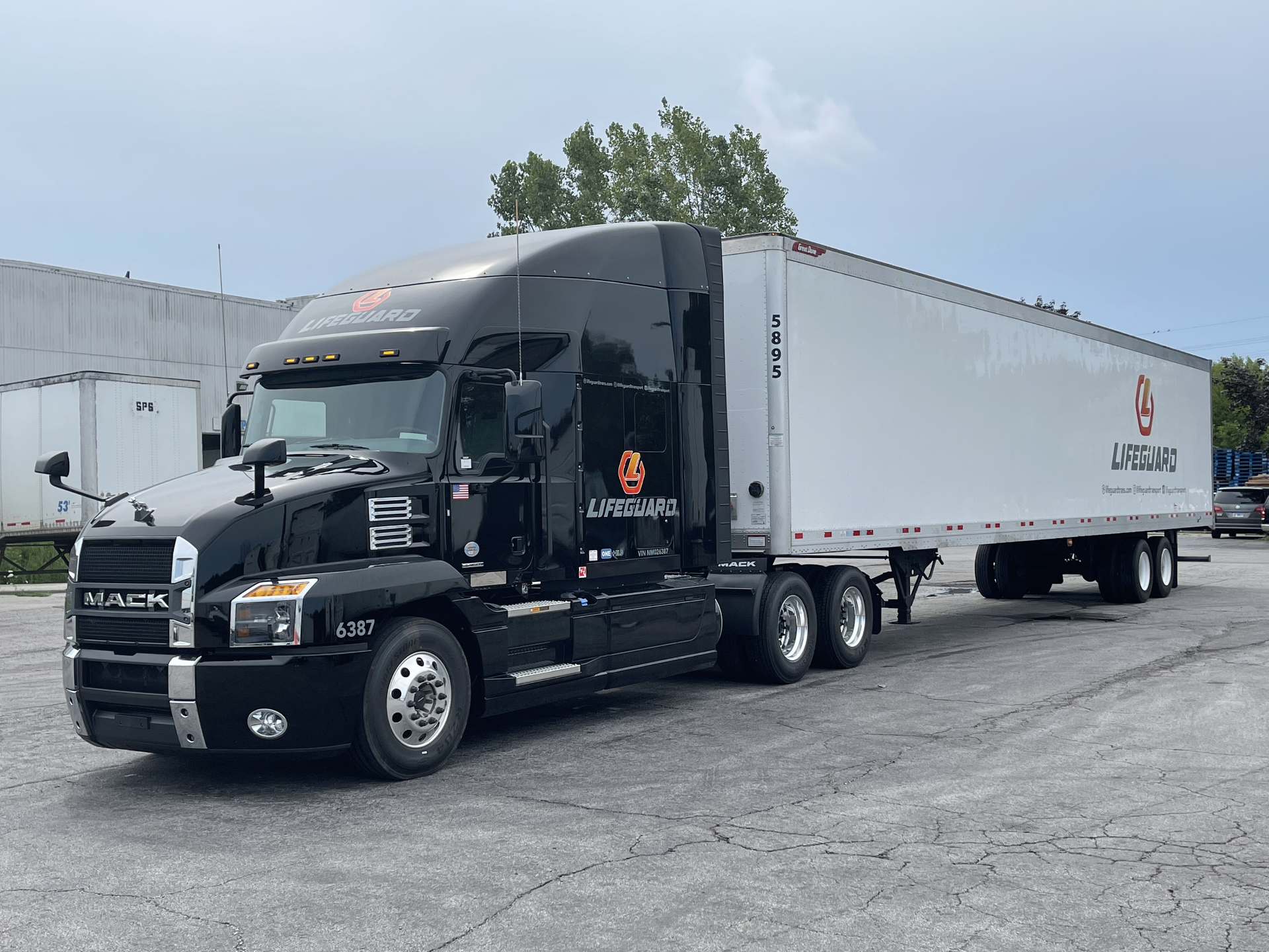 Black Mack Anthem tractor with white dry van trailer