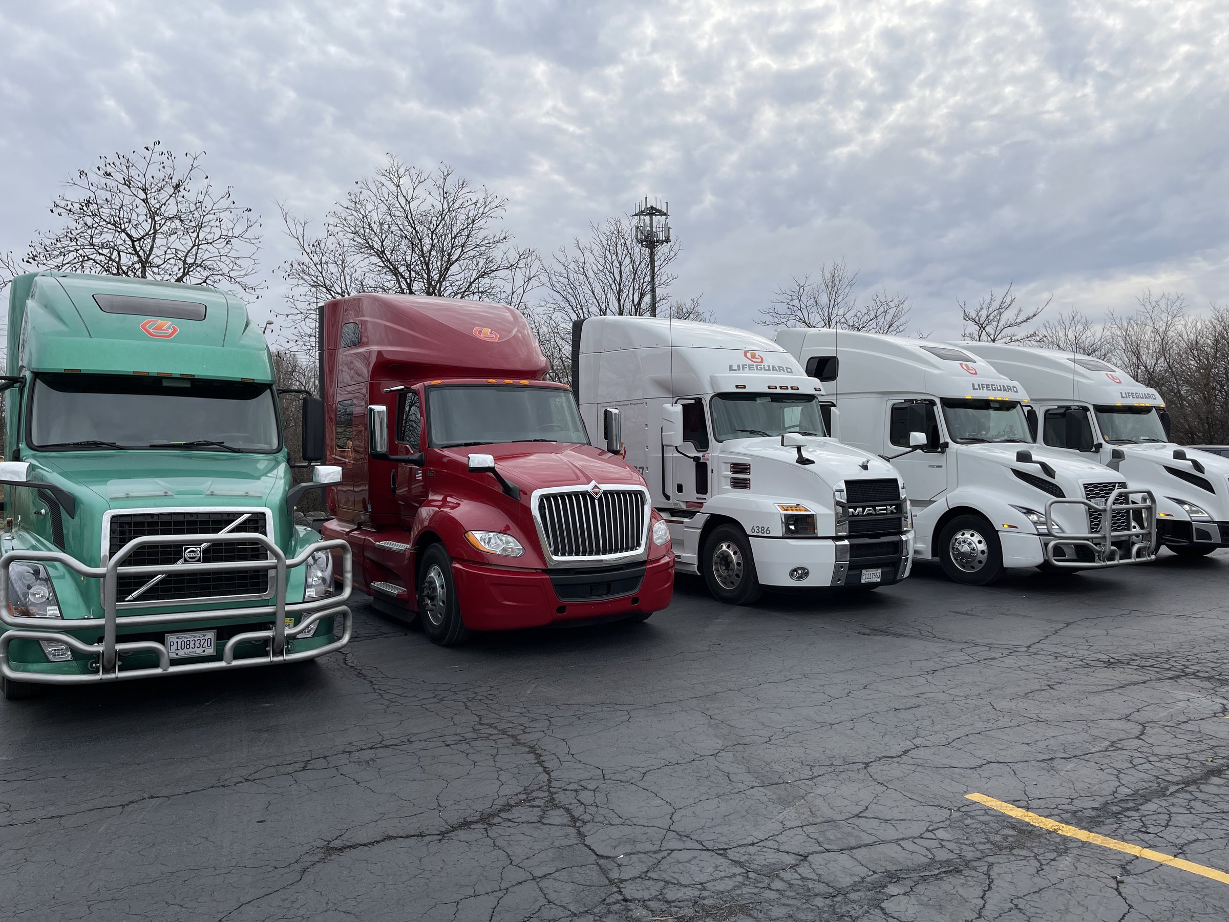 Lifeguard Transportation fleet including Volvo, International, and Mack tractors
